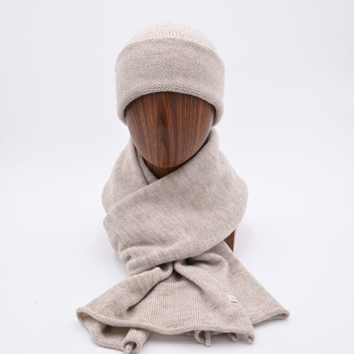 Mannequin wearing an Oatmeal cuffed beanie with a subtle pattern, made of alpaca and merino wool matching Scarf. (frnt)