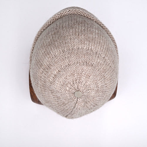 Manny wearing an Oatmeal cuffed beanie with a subtle pattern. (top)