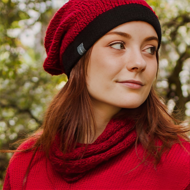 Model wearing a Berry Queenstown Slouchy and Cowl outdoors with blurred trees in the background