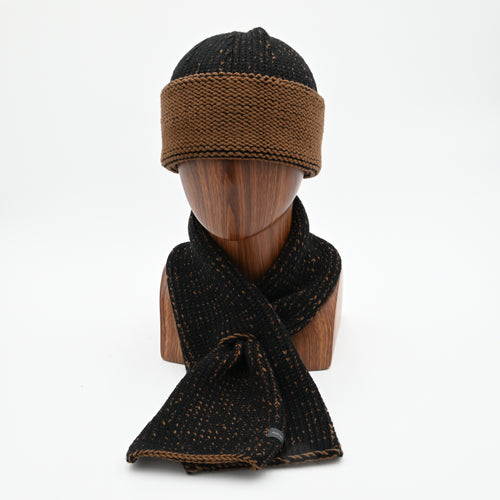 A oxen cuffed toque with a silver bean design at the crown and a matching ascot scarf
