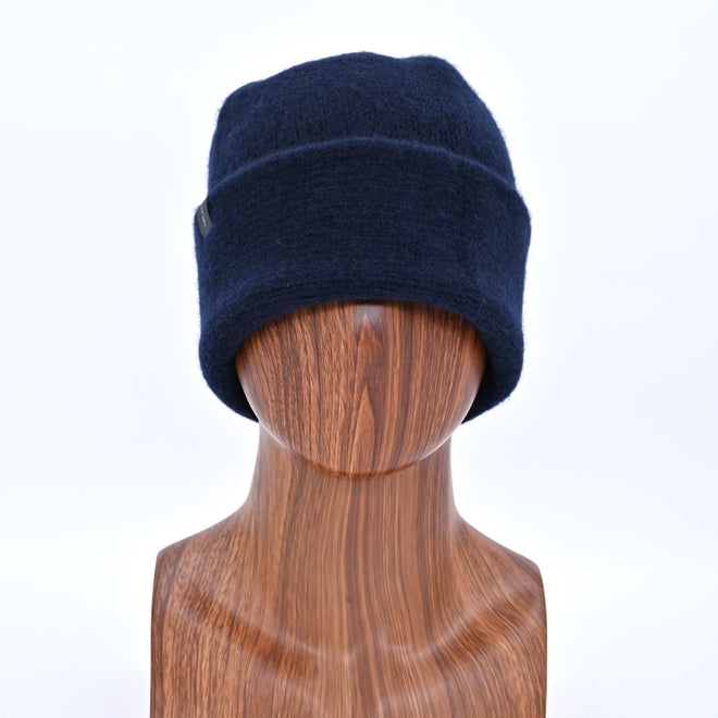 Midnight Navy Toque on a wooden mannequin head.
