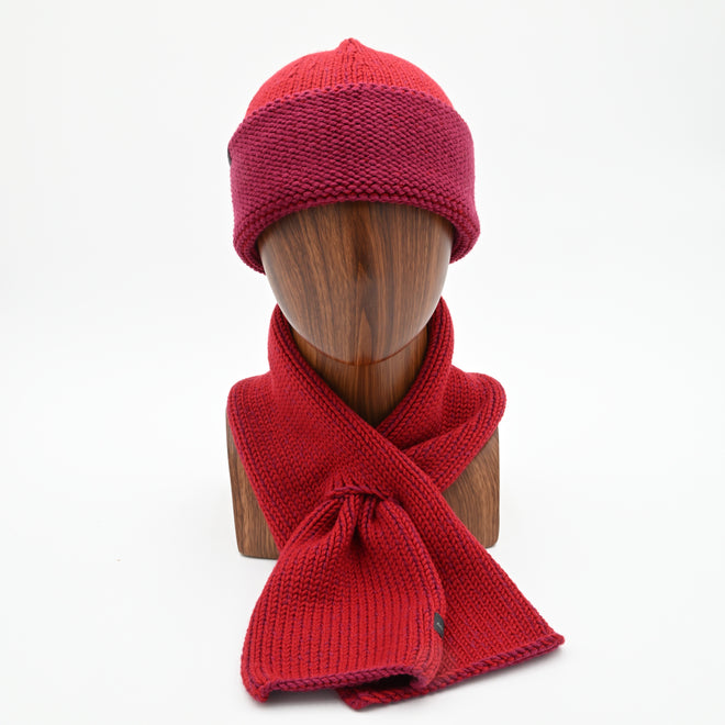 A mannequin wearing a marbled Cuffed Toque in Peacock. The Toque features a silver bean at the crown. This is shown here with a matching Ascot Scarf.