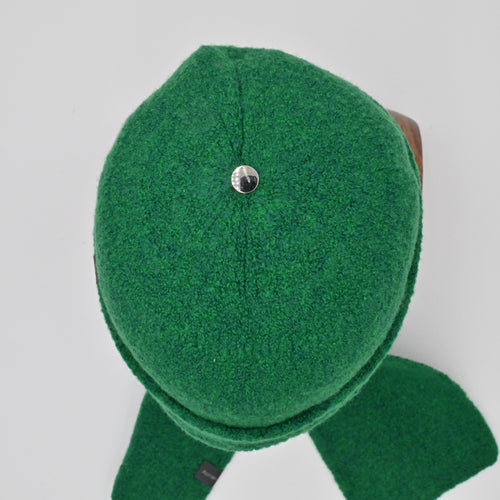 Green felted Toque with a silver bean on a light gray background
