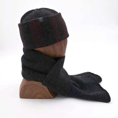 A mannequin wearing a dark gray tri-stripes felted toque with a cuffed design, and matching RGB 1800 scarf.