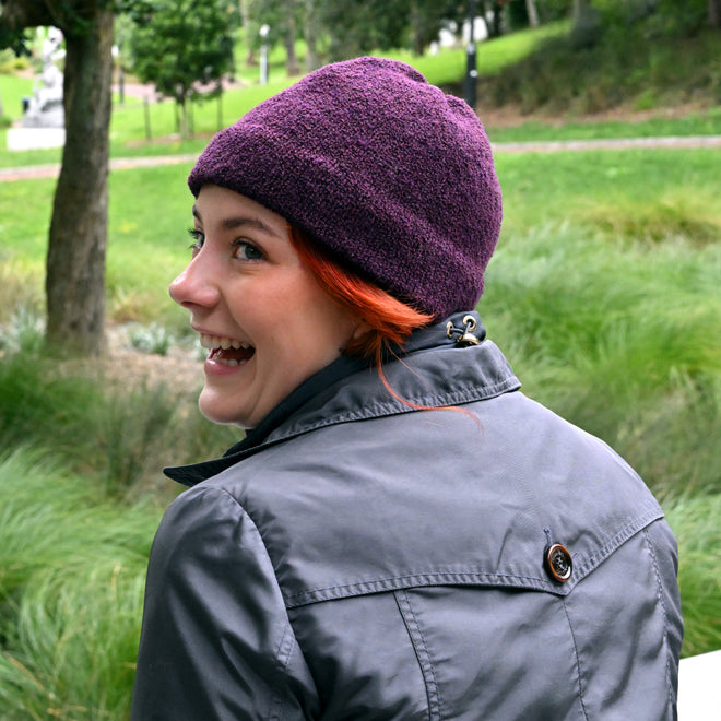 A model wearing a Plumb Milford All-weather toque knitted from 100% merino wool with a waterproof lining, perfect for the outdoors.