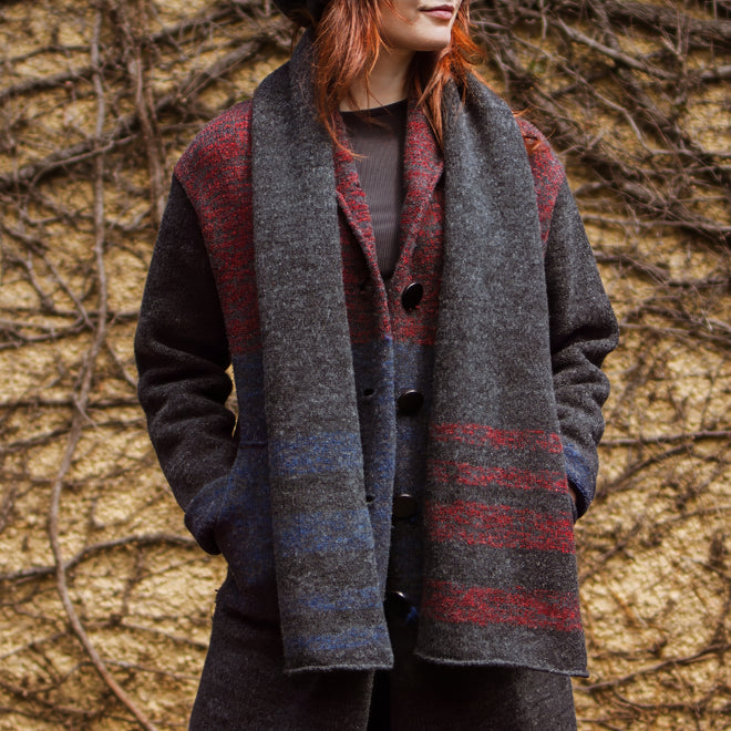 A model wearing a Tri-Stripe RGB Felted Scarf paired with a matching coat.