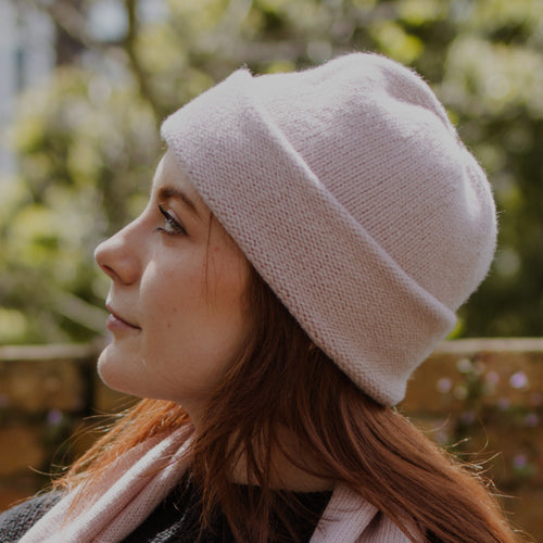 A model wearing an Egmont Beanie and matching scarf in Ice Blue. The Beanie features a silver bean at the crown. Shown here with a matching Classic Scarf.