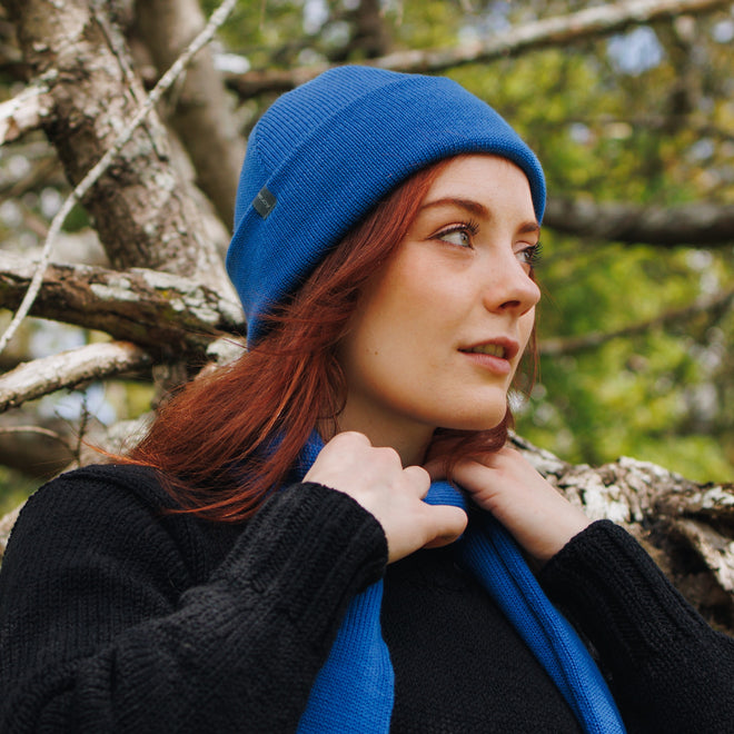 A modal wearing a Azure Blue Cuffed Felted Wanaka Toque and matching Fringed Scarf