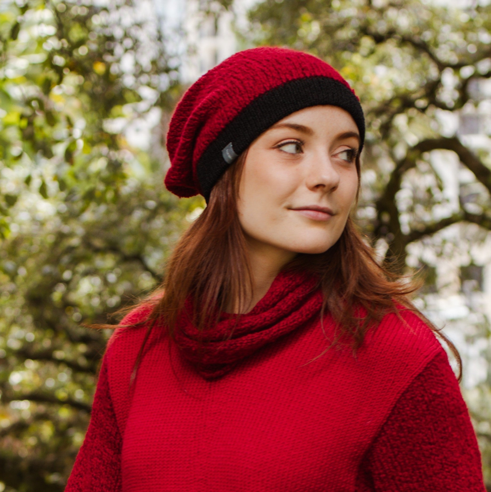 Girl wearing red and black Slouchy and matching infinity scarf