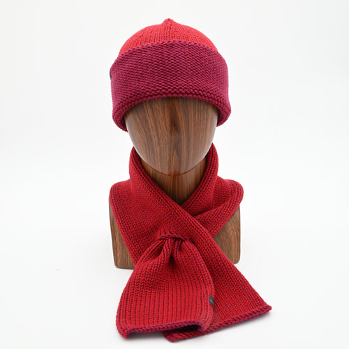 A peacock cuffed toque with a silver bean design at the crown and a matching ascot scarf