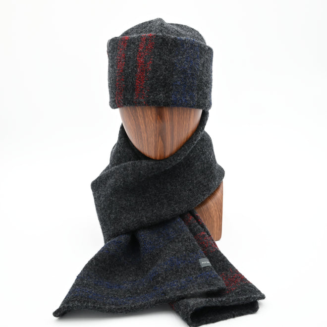A mannequin wearing a RGB Tri-stripes felted toque with a cuffed design, and matching felted 1800 standing. Front