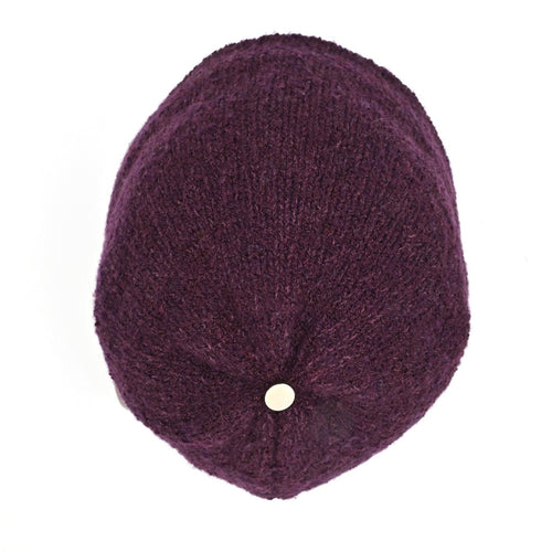 A model wearing a Plumb Milford All-weather toque knitted from 100% merino wool with a waterproof lining, perfect for the outdoors.