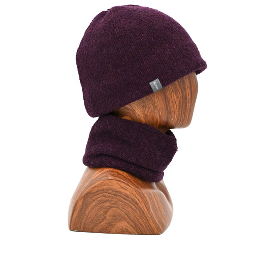 A model wearing a Plumb Milford All-weather toque knitted from 100% merino wool with a waterproof lining, perfect for the outdoors. Paired with an Active Infinity Cowl