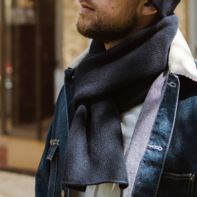 A closeup Model wearing a Felted Classic Scarf in shades of Gunmetal.